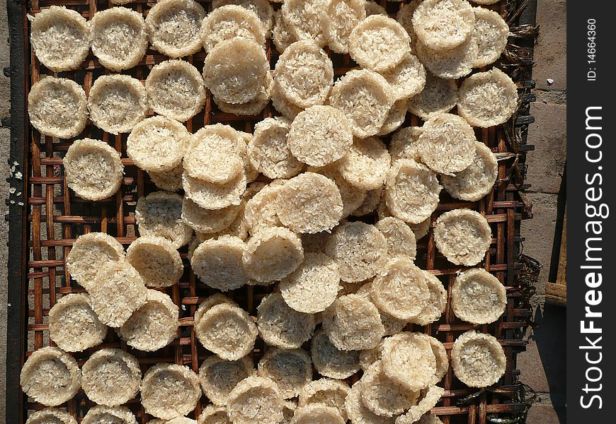 Overhead view of sticky rice cakes drying in the sun in Luang Prabang, Laos. Overhead view of sticky rice cakes drying in the sun in Luang Prabang, Laos.