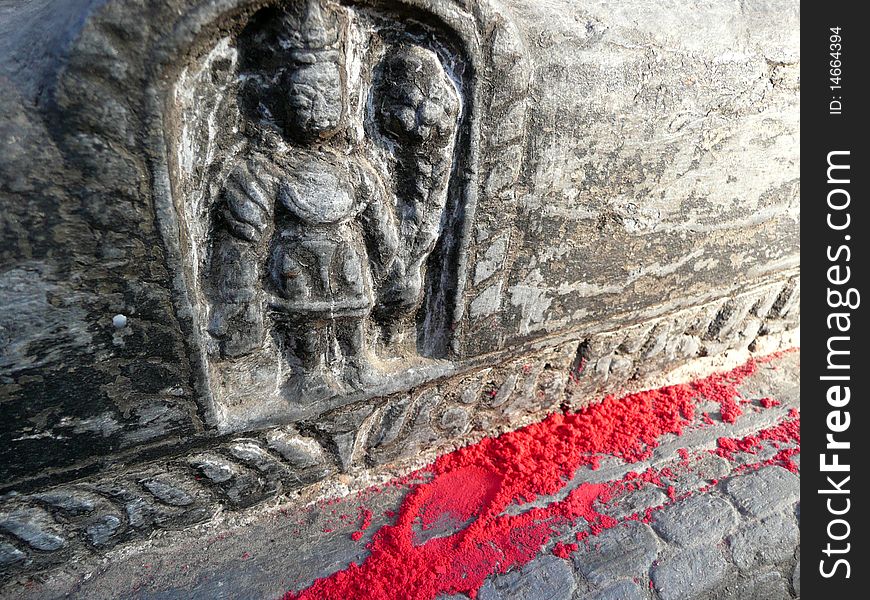 Red powder scattered at the base of a small bas-relief carving, in stone, at a Buddhist Temple in Kathmandu, Nepal. Red powder scattered at the base of a small bas-relief carving, in stone, at a Buddhist Temple in Kathmandu, Nepal.