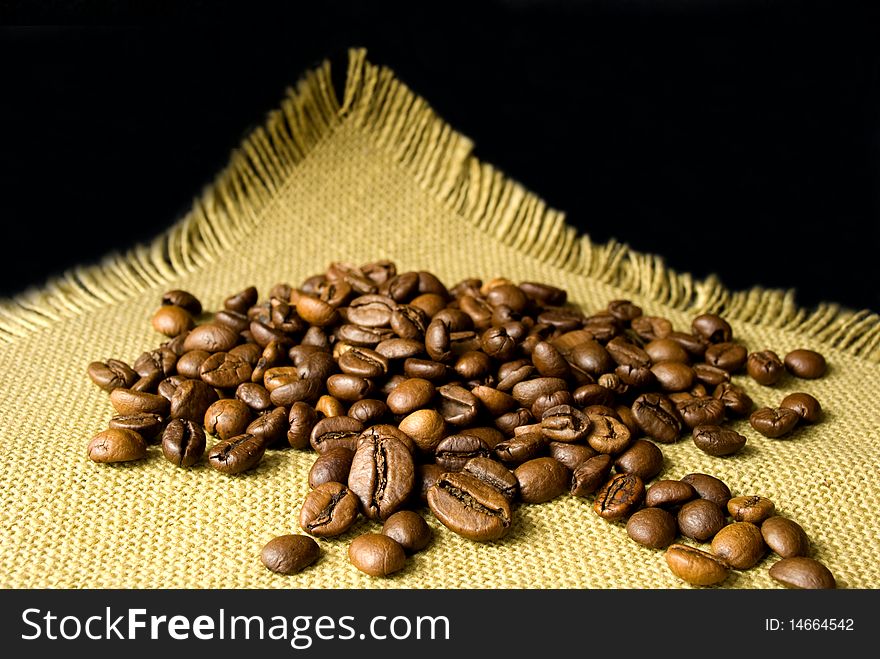 Many Coffee beans on a yellow cloth