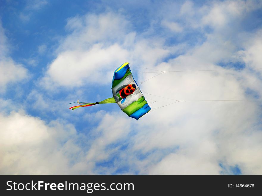 Photo of kite flying high in the blue sky. Photo of kite flying high in the blue sky