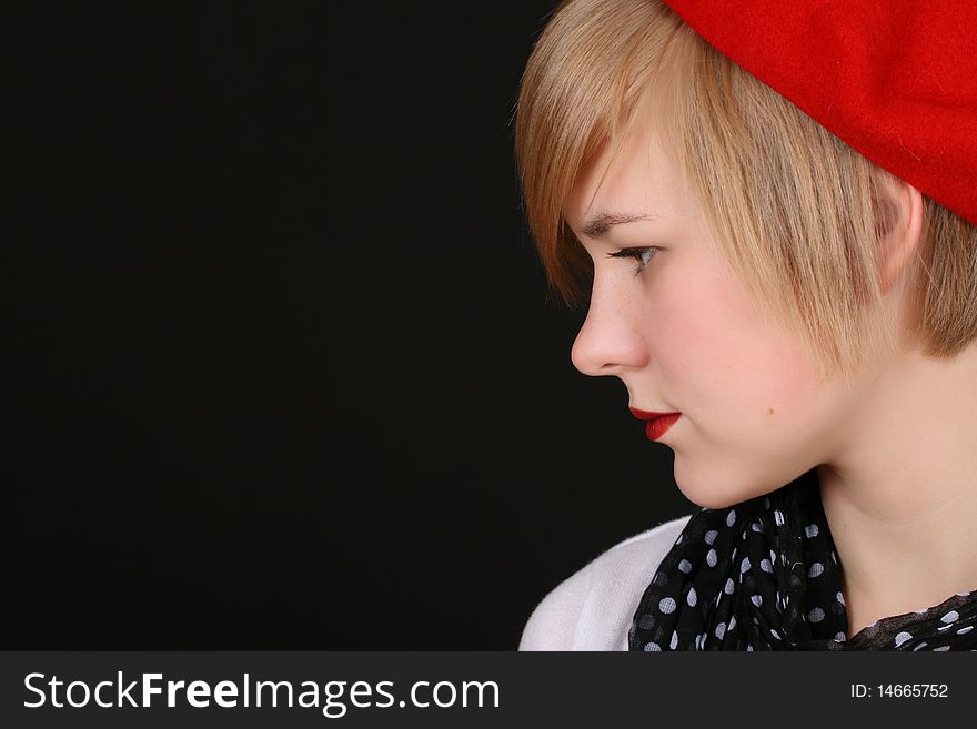 Beautiful young blond female wearing a red hat. Beautiful young blond female wearing a red hat