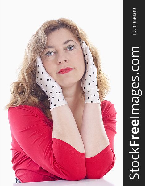 Portrait of a middle-aged woman in red with polka-dot gloves - isolated on white. Portrait of a middle-aged woman in red with polka-dot gloves - isolated on white