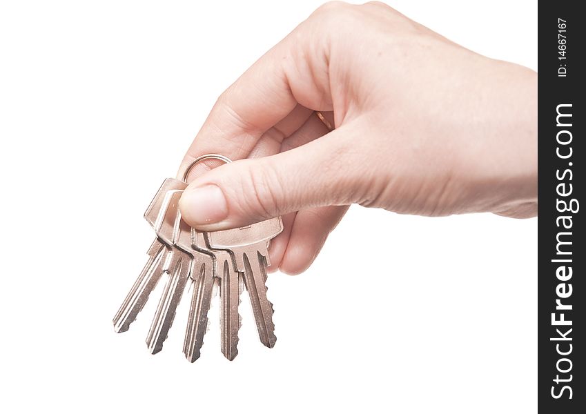 Metal keys in woman hand isolated on the white background. Metal keys in woman hand isolated on the white background