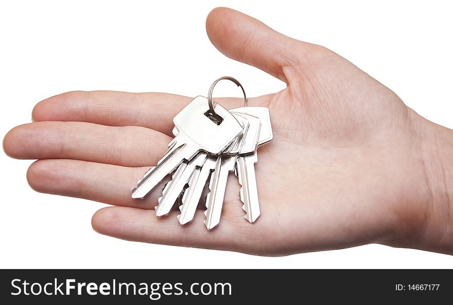 Metal keys in woman hand isolated on the white background. Metal keys in woman hand isolated on the white background