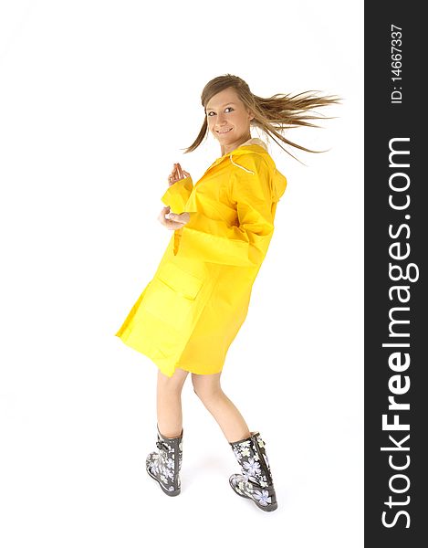 Happy and beautiful woman in yellow raincoat on rainy day