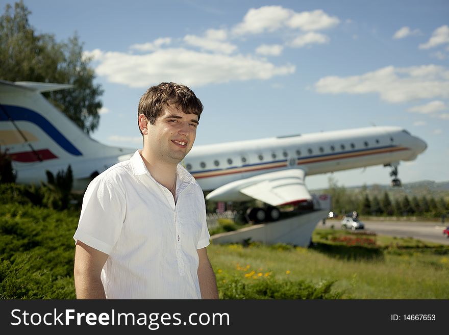 Man posing with an airplane behind. Man posing with an airplane behind
