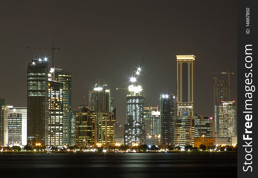 Doha, the capital of Qatar under construction at night. Doha, the capital of Qatar under construction at night