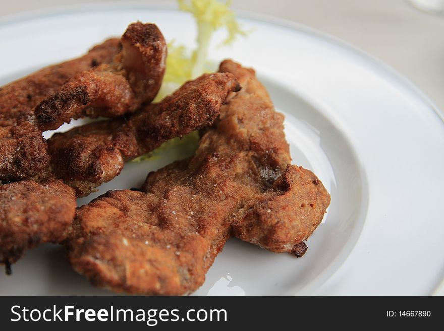 Deep fried breaded lamb on a dish. Deep fried breaded lamb on a dish