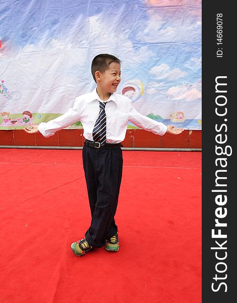 A student is performing on the stage on Children's Day in a primary school. A student is performing on the stage on Children's Day in a primary school.