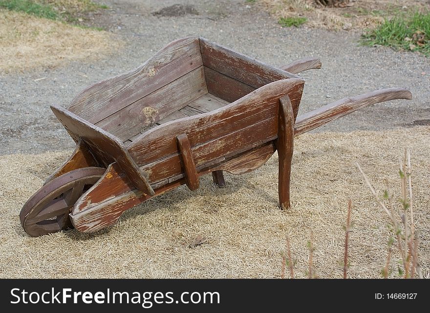 The old empty wooden wheelbarrow