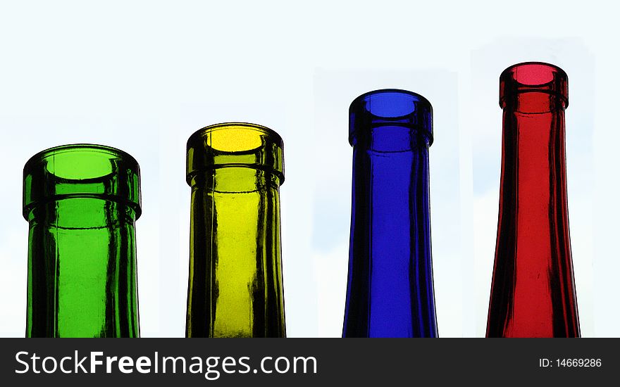 Four glass bottles in different colours, red, yellow, blue, green. Four glass bottles in different colours, red, yellow, blue, green