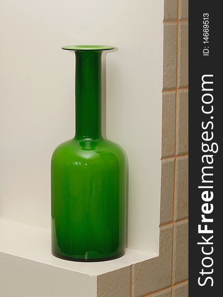 The green bottle costs in a wall niche