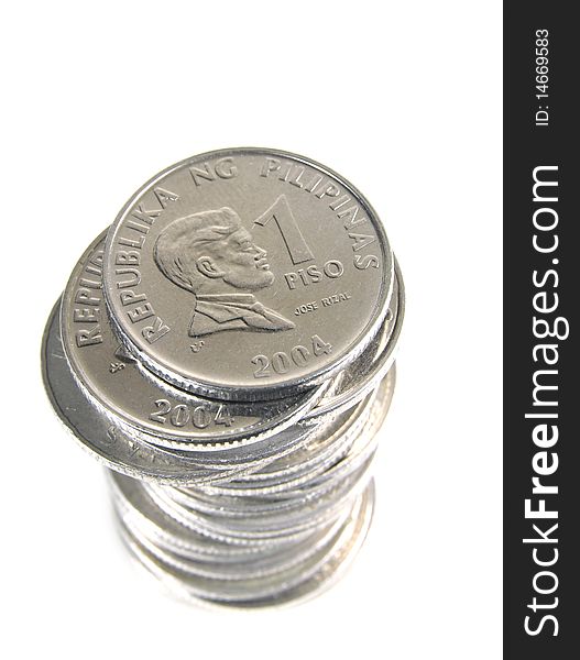 Stack of 1 peso coins from Philippines on white background