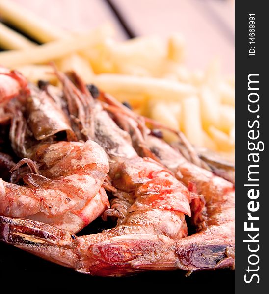 Prepared fried prawns and french fries. Prepared fried prawns and french fries