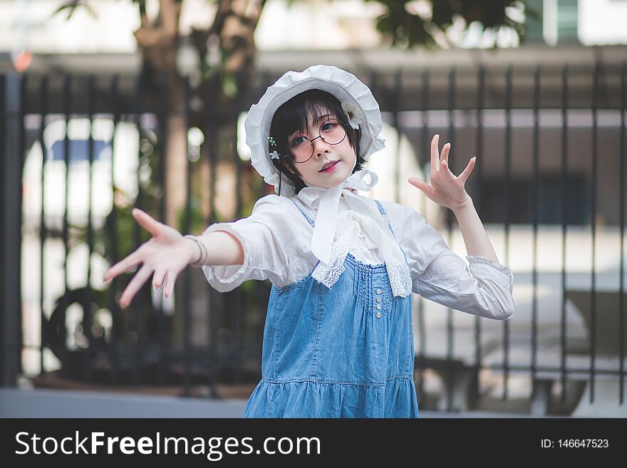 Cute short haired Asian women, Thai people, dressed in Japanese cosplay coses in a concept outdoor during the day at studios in Bangkok, Thailand. with copy space. Cute short haired Asian women, Thai people, dressed in Japanese cosplay coses in a concept outdoor during the day at studios in Bangkok, Thailand. with copy space