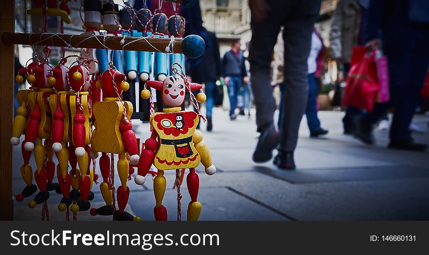 Wooden clown smile and walking people in Vienna, Austria