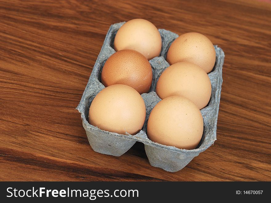 Six eggs in a blue container