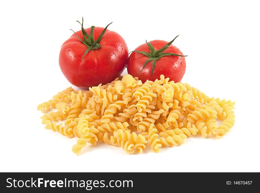 Italian pasta fusilli and tomatoes on white background