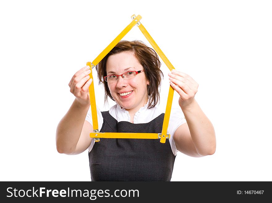 Young attractive female with red specs, holds yellow measure in the shape of house, studio shoot isolated on white background. Young attractive female with red specs, holds yellow measure in the shape of house, studio shoot isolated on white background