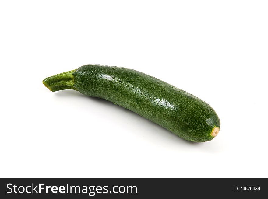 A single zucchini isolated on white background. A single zucchini isolated on white background