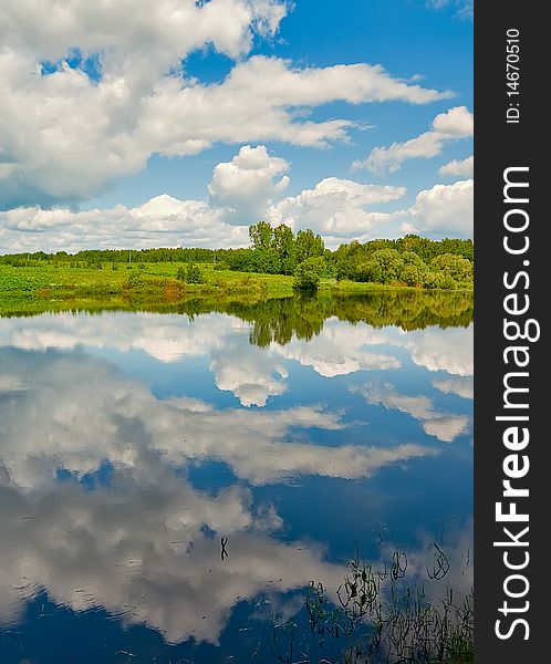 Cloud reflection in the rural russian river with forest on horizon. Cloud reflection in the rural russian river with forest on horizon