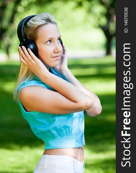 Girl with headphones in park