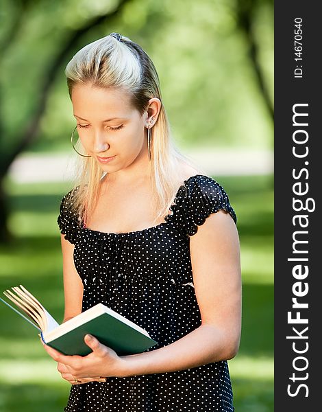 Girl with book in park