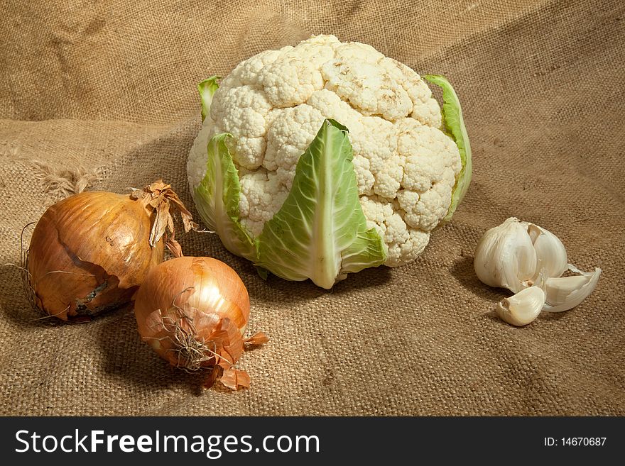 Still-life with cauliflower cabbage, onion and garlic