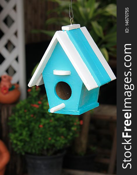 Blue bird house on blur background