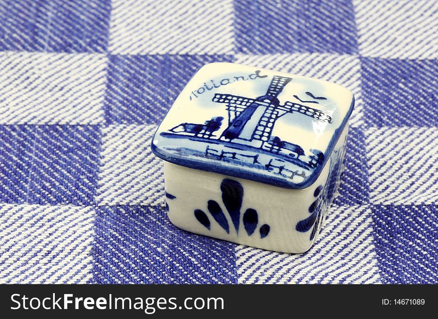 Ceramic pill box on a blue checkered kitchen towel