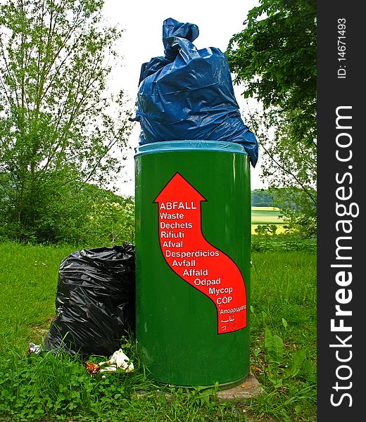 Overcrowded litter bin on a car park