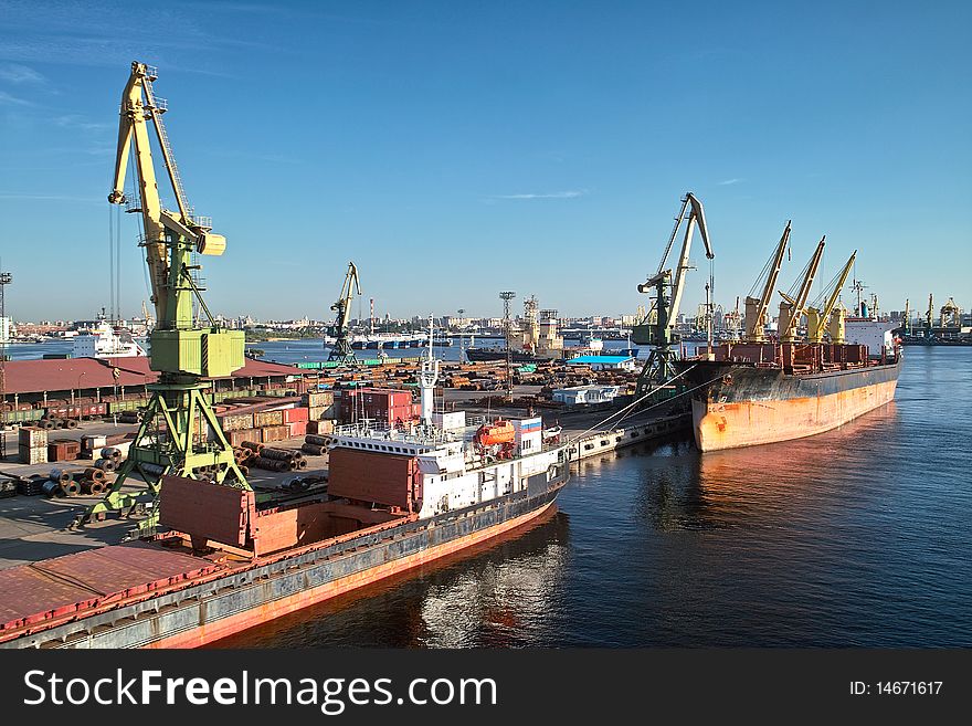 Cargoships and cranes in the harbor. Cargoships and cranes in the harbor