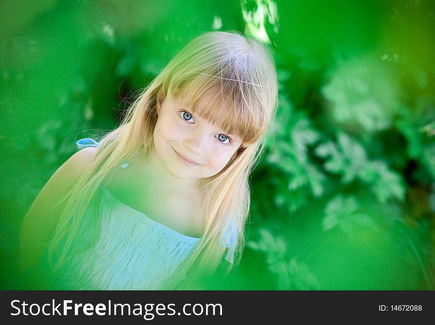 Little girl  under the trees outdoor