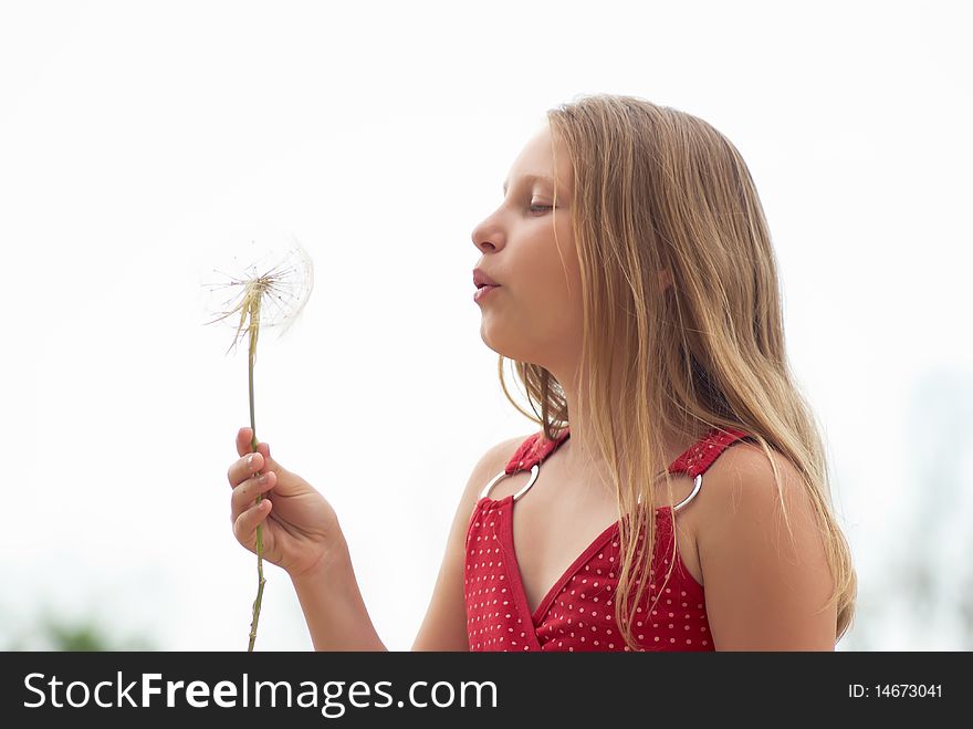 Girl with dandelion on a light background