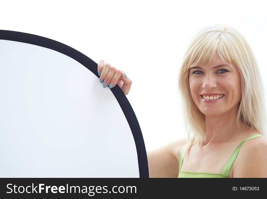 The woman hold in hands a photographic reflector