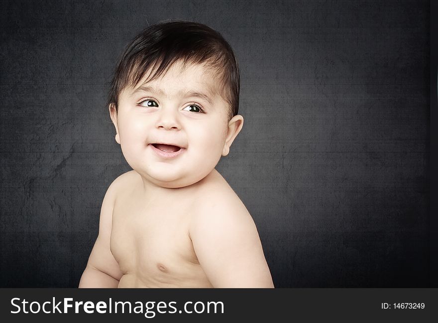 A cute chubby baby laughing.