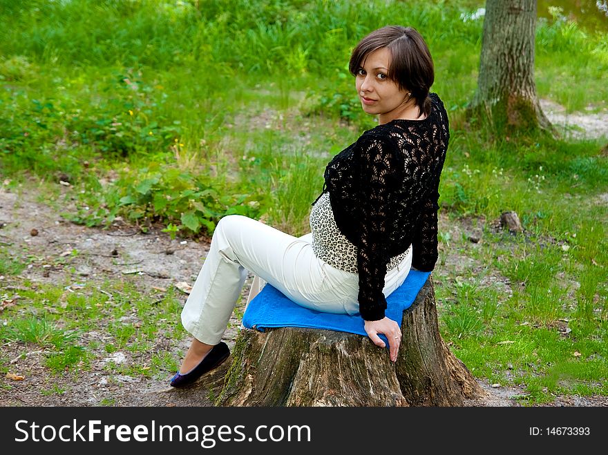 Beautiful pregnant girl in the park. Outdoor shot