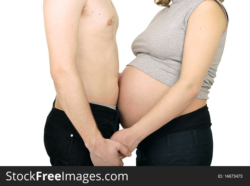 Happy couple expecting a baby are holding hands. Happy couple expecting a baby are holding hands