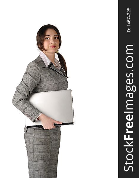 The young and beautiful business lady with the laptop under the arm looks in the camera on a white background. The young and beautiful business lady with the laptop under the arm looks in the camera on a white background