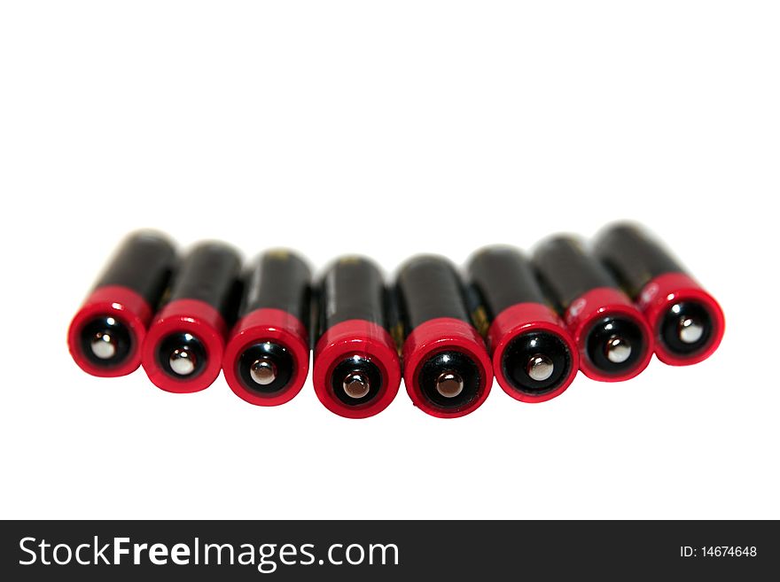 Batteries grouped together in a row against a white background. Batteries grouped together in a row against a white background