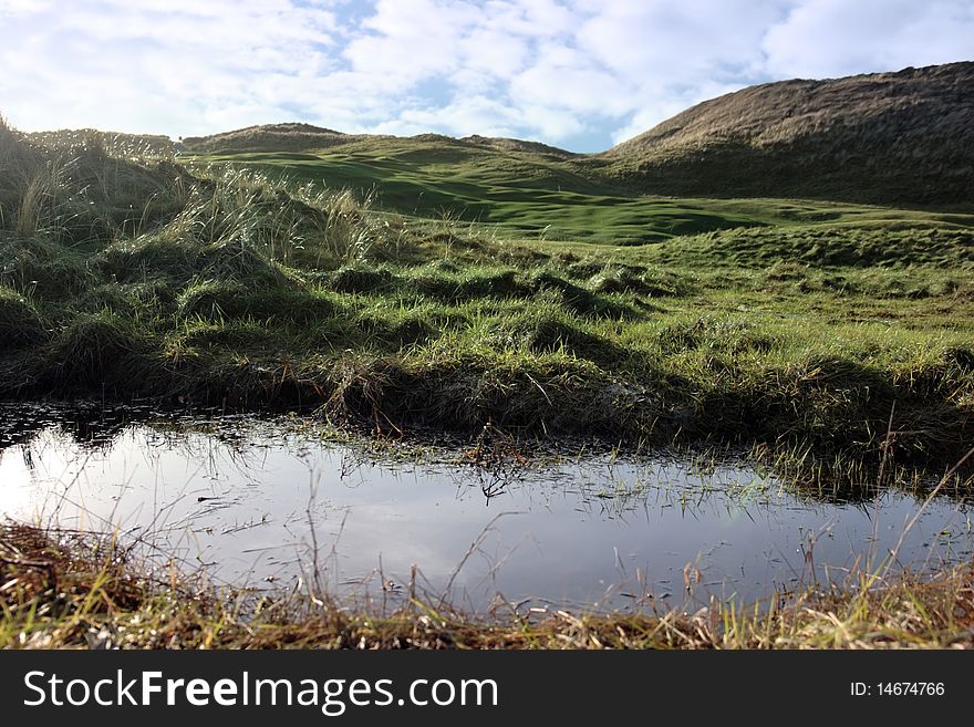 A water trap on a links golf course in ireland. A water trap on a links golf course in ireland