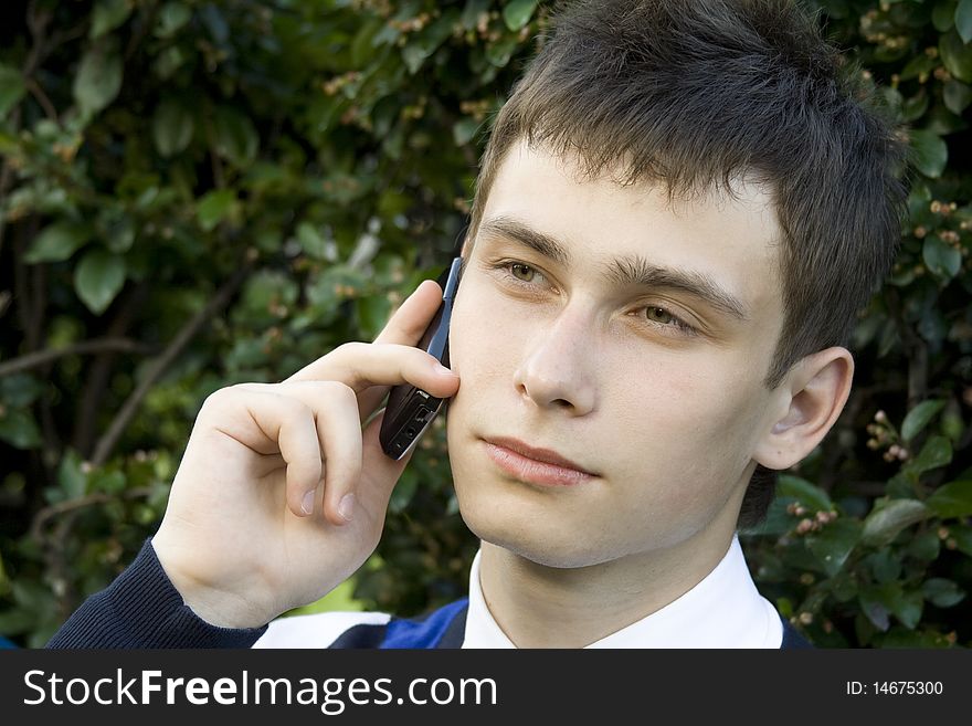 Teenager outdoors talking on the phone. Teenager outdoors talking on the phone