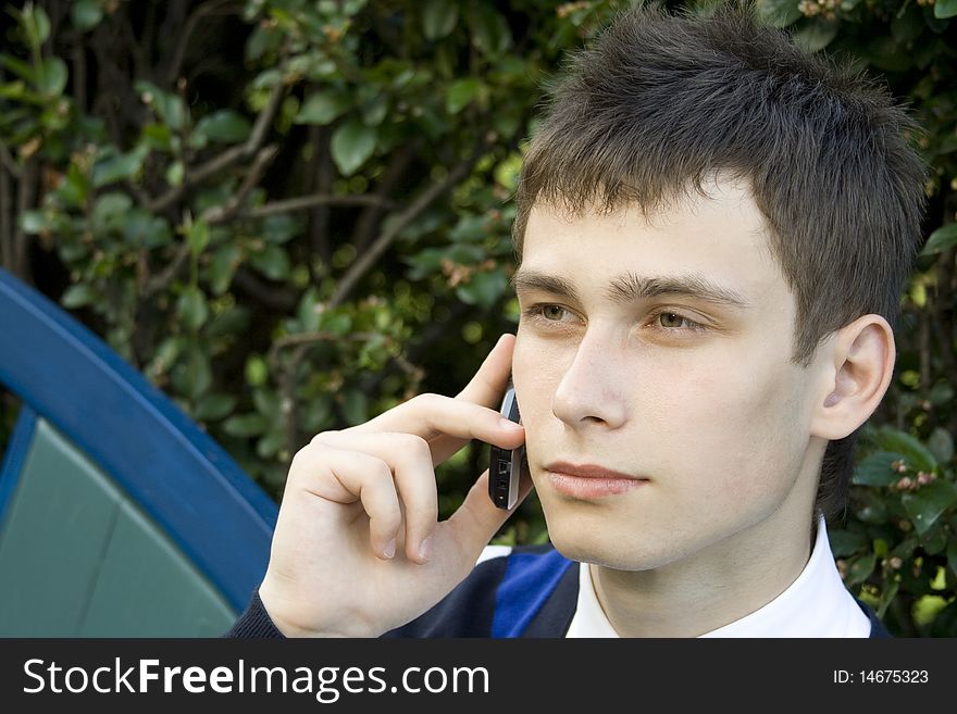 Teenager outdoors talking on the phone. Teenager outdoors talking on the phone