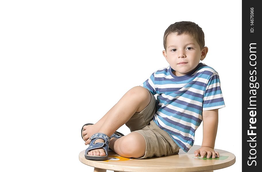 Child posing on a table ( isolated on white ). Child posing on a table ( isolated on white )
