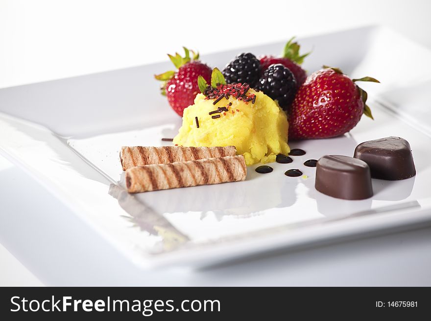 Elegant dessert plate with sorbet,fruit,cookies and chocolate. Elegant dessert plate with sorbet,fruit,cookies and chocolate