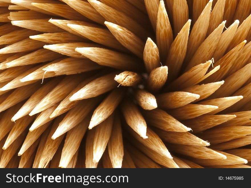 A close up of plain wooden toothpicks ready to be used.