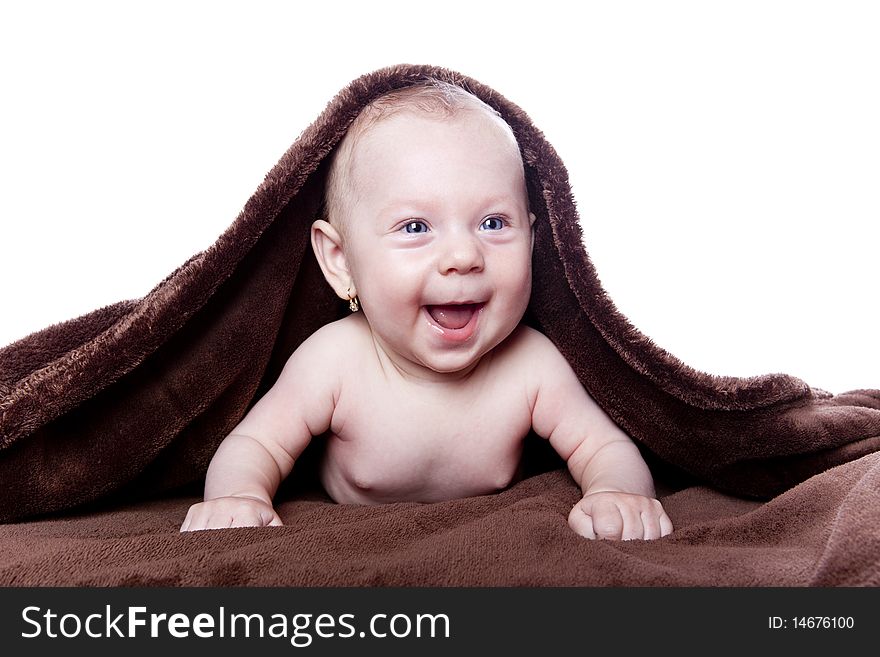 A beautiful baby under a brown towel on white background