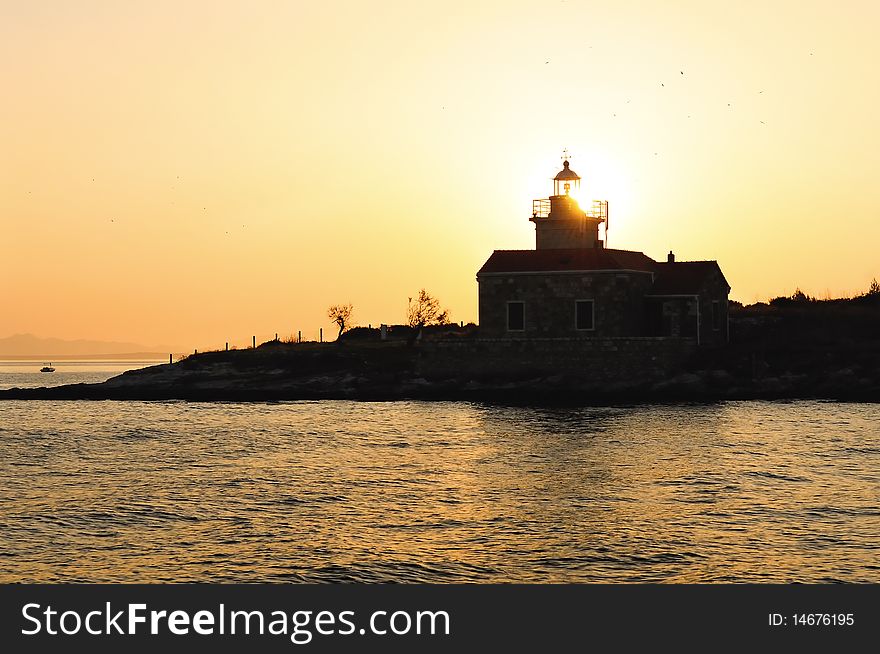 A small lighthouse at sunset. Croatia.