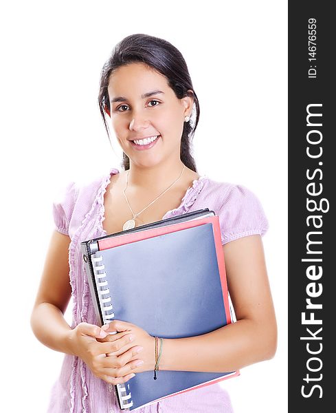 Young student with her books in hand, smiling and looking at the camera