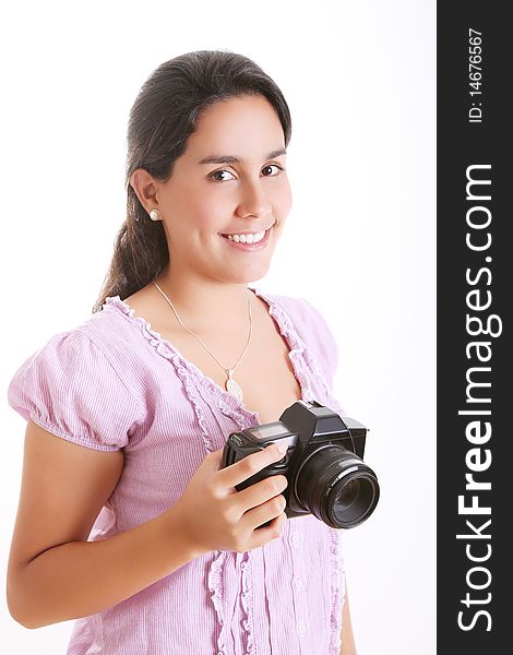 Young girl with a camera in his hands looking at the camera and smiling